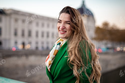 Preview: Young woman wearing green smiling at camera