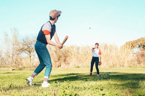 Preview: Young couple playing baseball in park