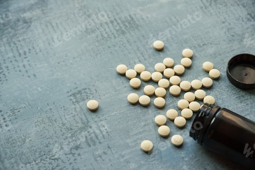 Preview: yellow round tablets or pills vitamins
