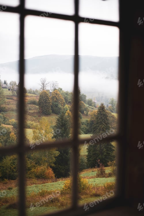 Preview: view through the window on a mountain landscape