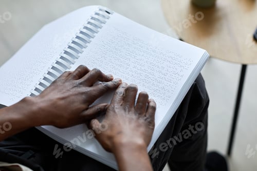 Preview: Man Reading Book in Braille Closeup