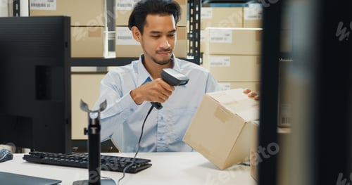 Preview: man wear formal uniform shirt sit in front of desk use computer and barcode machine scanner record.