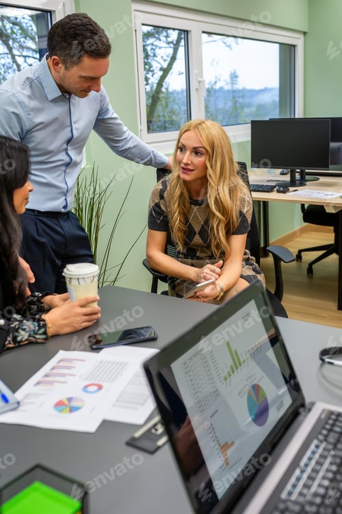 Preview: Group of business colleagues gossiping together during break in coworking office