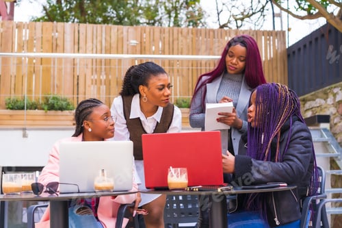 Preview: Young businesswomen of black ethnicity. In a business meeting in a cafeteria