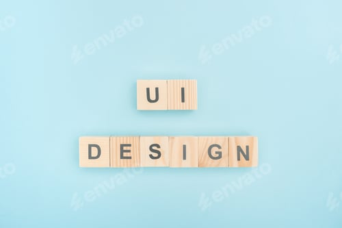 Preview: top view of ui design lettering made of wooden cubes on blue background