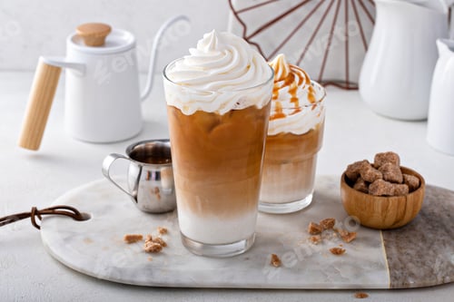 Preview: Iced caramel latte topped with whipped cream and caramel sauce