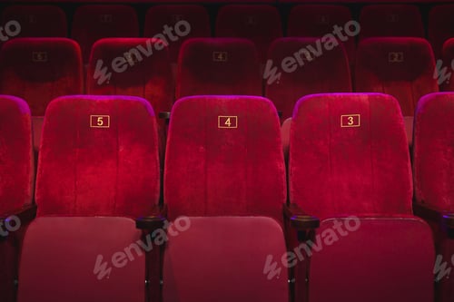Preview: Empty comfortable red seats with numbers in the cinema