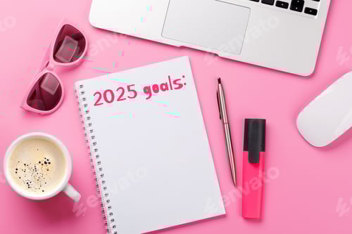 Preview: Modern pink desk with laptop, coffee, stationery, and a notepad titled 2025 Goals