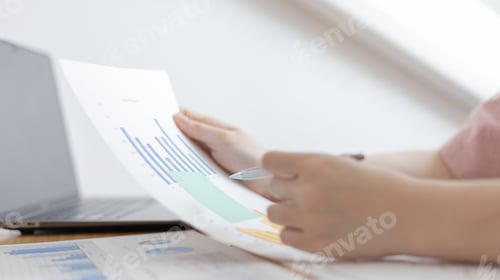 Preview: Analyzing Business Data at a Desk with Laptop