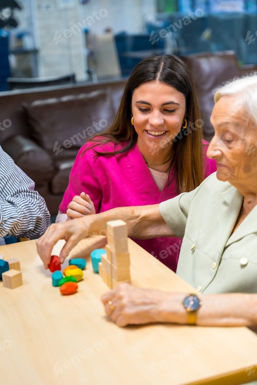 Preview: Nurse helping elder people to play in a nursing home