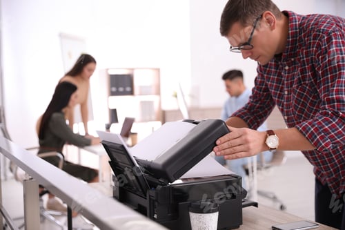 Preview: Employee using new modern printer in office