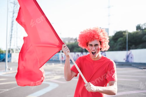 Preview: Soccer fan screaming and cheering for his team with a flag and his team's colors. Concept: fans