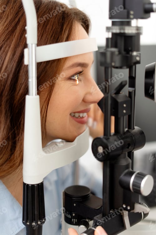 Preview: Close up of smiling young woman taking eye care