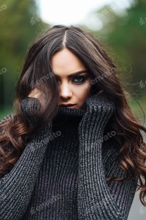 Preview: Attractive Woman in a Dark Turtleneck Outdoors