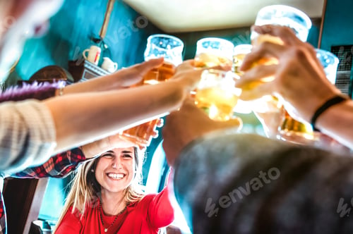 Preview: Friends drinking and toasting beer at brewery bar restaurant