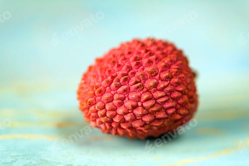 Preview: Single lychee on wooden background close