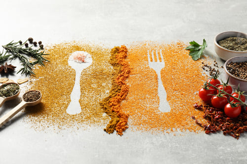 Preview: Different spices and silhouettes of cutlery on light grey table