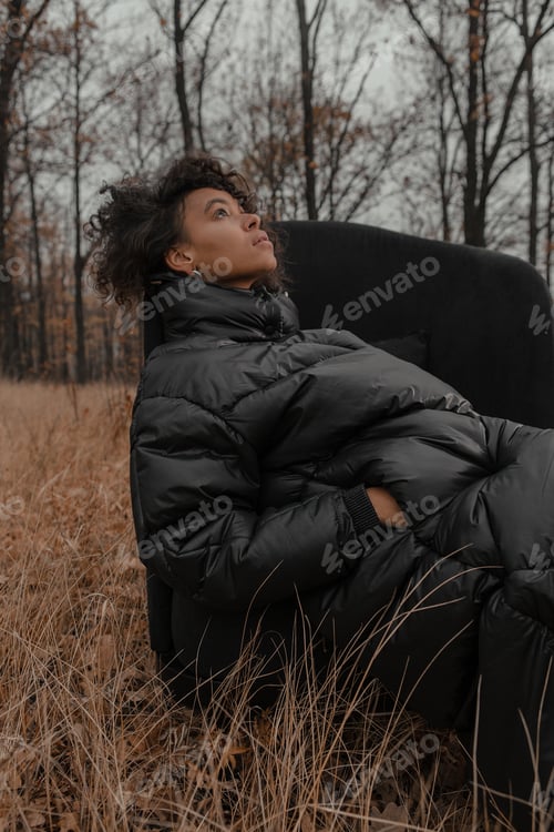 Preview: Beautiful Girl With Curly Hair In A Stylish Suit Walks Against The Backdrop Of A Beautiful Landscape