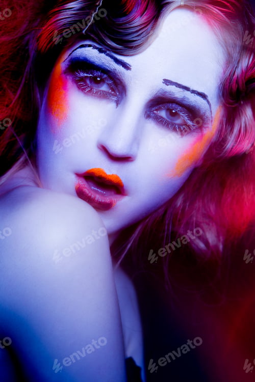 Preview: High Fashion model woman in colorful bright lights posing in studio