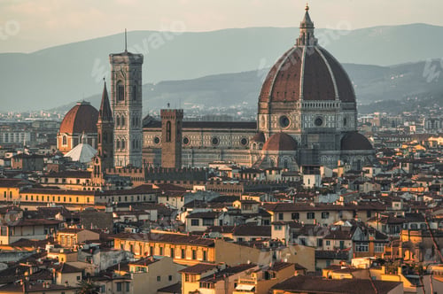 Preview: a large tower sitting above the town of florence and a building that has a dome