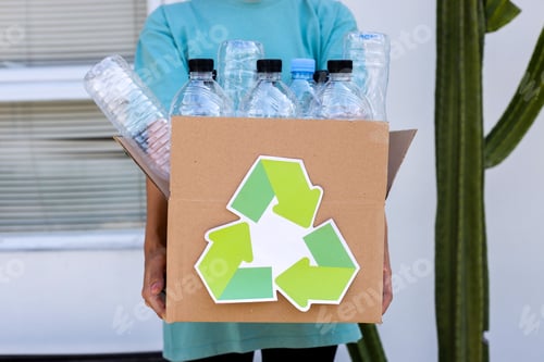 Preview: Close Up Of Hand Holding Box Of Plastic Bottles. Reuse Reduce Recycle Concept.