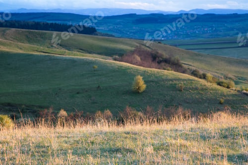 Preview: amazing sunset sky over green hills in early summer