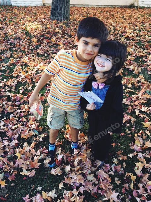 Preview: Brother and sister in fall leaves