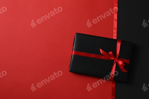 Preview: Ribbons and gift box on red background, space for text
