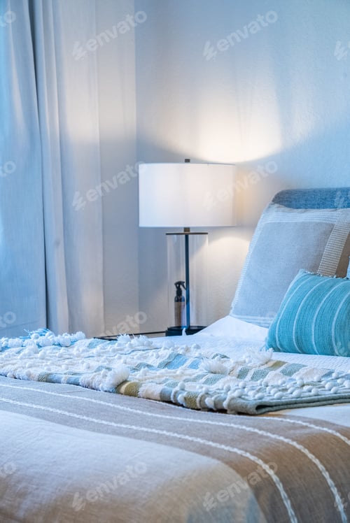 Preview: Cozy bedroom scene featuring a bed with pillows and a white blanket