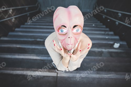 Preview: young woman outdoor posing wearing alien mask