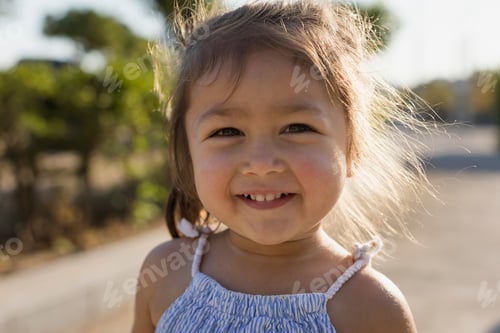 Preview: Portrait of happy little girl outdoors