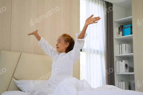 Preview: Senior woman is stretching after wake up.