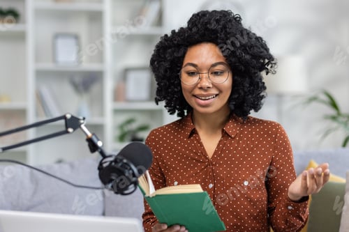 Preview: Home recording online studio. Young smiling African American woman sitting on sofa in front of