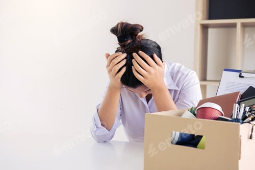 Preview: Woman employee used his hand to hold the head feeling sad at his desk