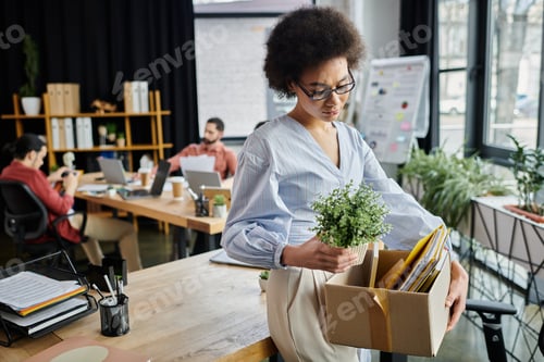 Preview: Colleagues in Stylish Attire Navigating a Layoff Moment in a Modern Office Space