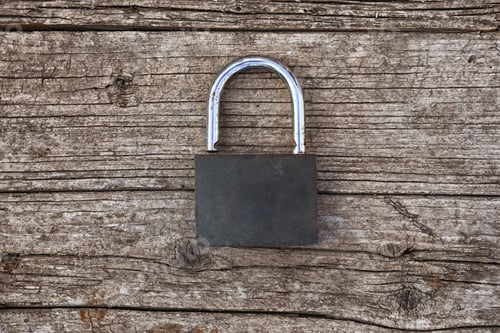 Preview: the old padlock lies on the wooden surface