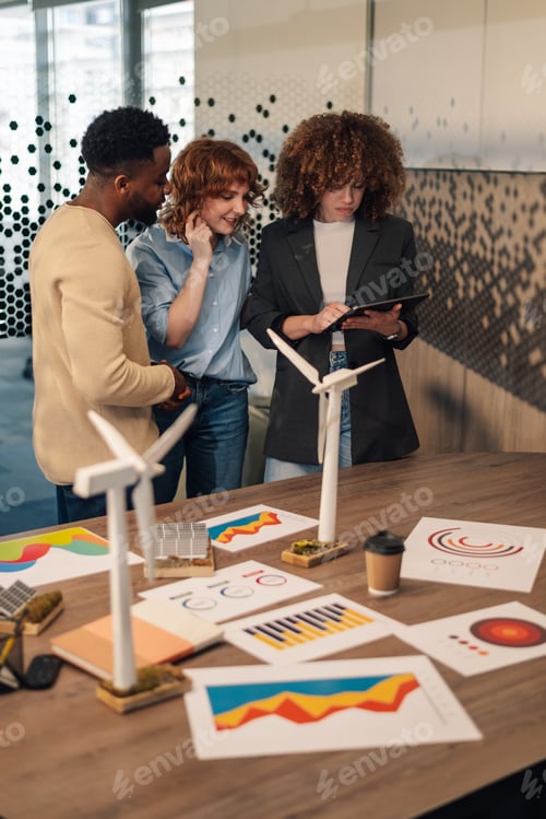 Preview: Interracial ecology engineers with tablet doing research for green economy