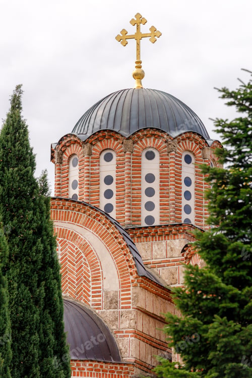 Preview: Beautiful church dome with cross under cloudy sky in a serene location