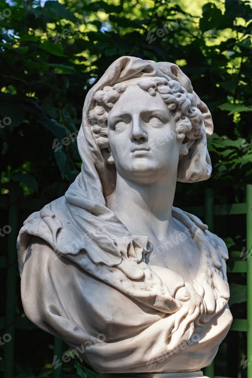 Preview: Close-up of sculpture woman's head made of white marble. Old statue of sensual sad woman in veil