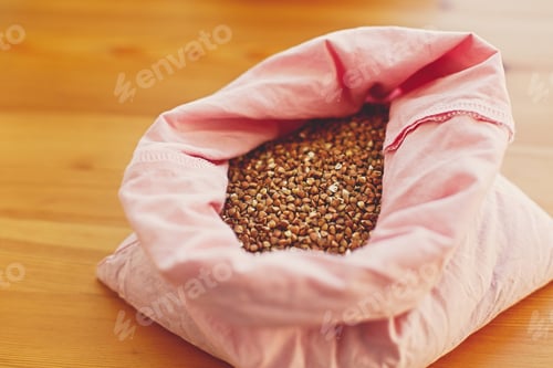 Preview: Groceries in reusable textile bags on wooden table, top view