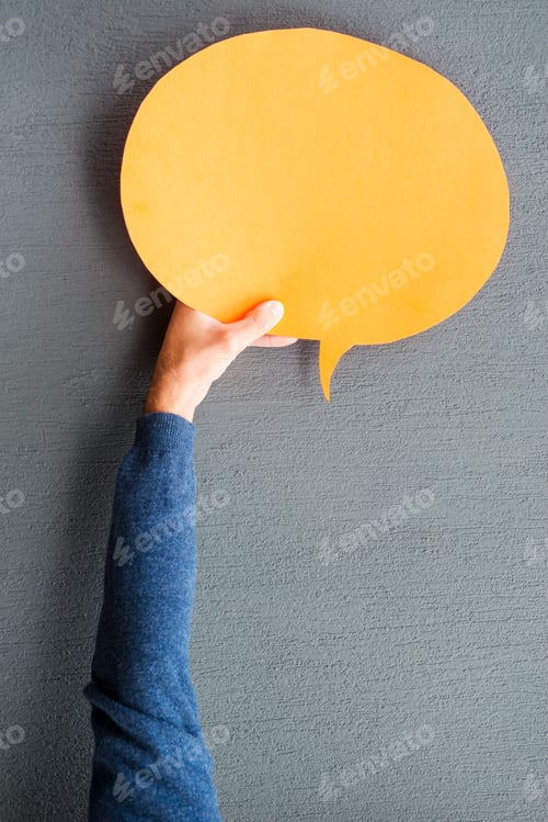 Preview: Speech bubble. Close-up of man stretching out empty speech bubble against grey background