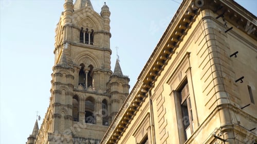 Preview: Bottom view of old architectural building with tower on sky background. Action. Medieval