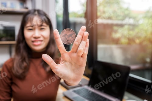 Preview: Copper Ripple coin (cryptocurrency) in hand of businesswoman. New Virtual money concept