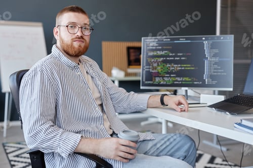 Preview: Portrait of Man Sitting in Office Holding Coffee