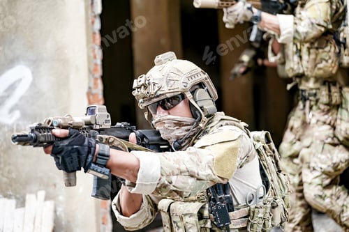 Preview: Soldier in full US MARSOC armed with assault rifle run through the abandoned building. Military