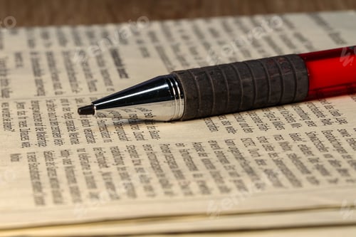 Preview: Closeup of a ballpoint pen lying on a newspaper