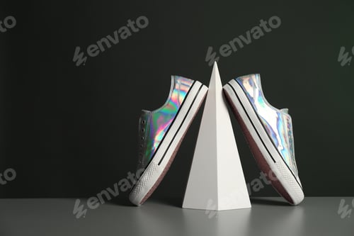 Preview: Composition with stylish shoes on table against dark background. Space for text