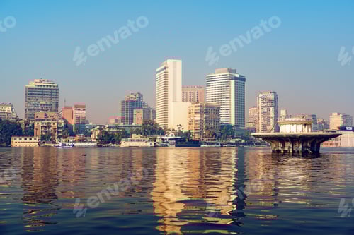 Preview: City skyline reflecting in the Nile River at sunset in Cairo