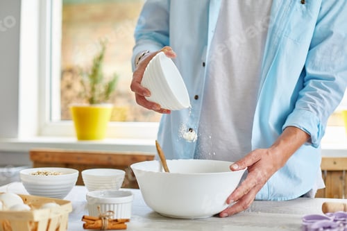 Preview: Man, male forming the dough in Bowl a and kneading at home