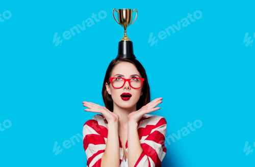Preview: young surprised woman with cup trophy